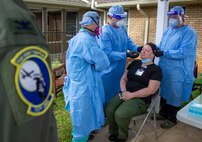 Col. Scott Coradi (left), 111th Medical Group commander and medical adviser for Pennsylvania Task Force South trains members of Task Force Ghostrider, Spc. Joshua Vargo (center) and Spc. Kristien Quintanilla (right) on proper procedures how to administer a COVID-19 test in Lancaster, Pa., on May 19, 2020.