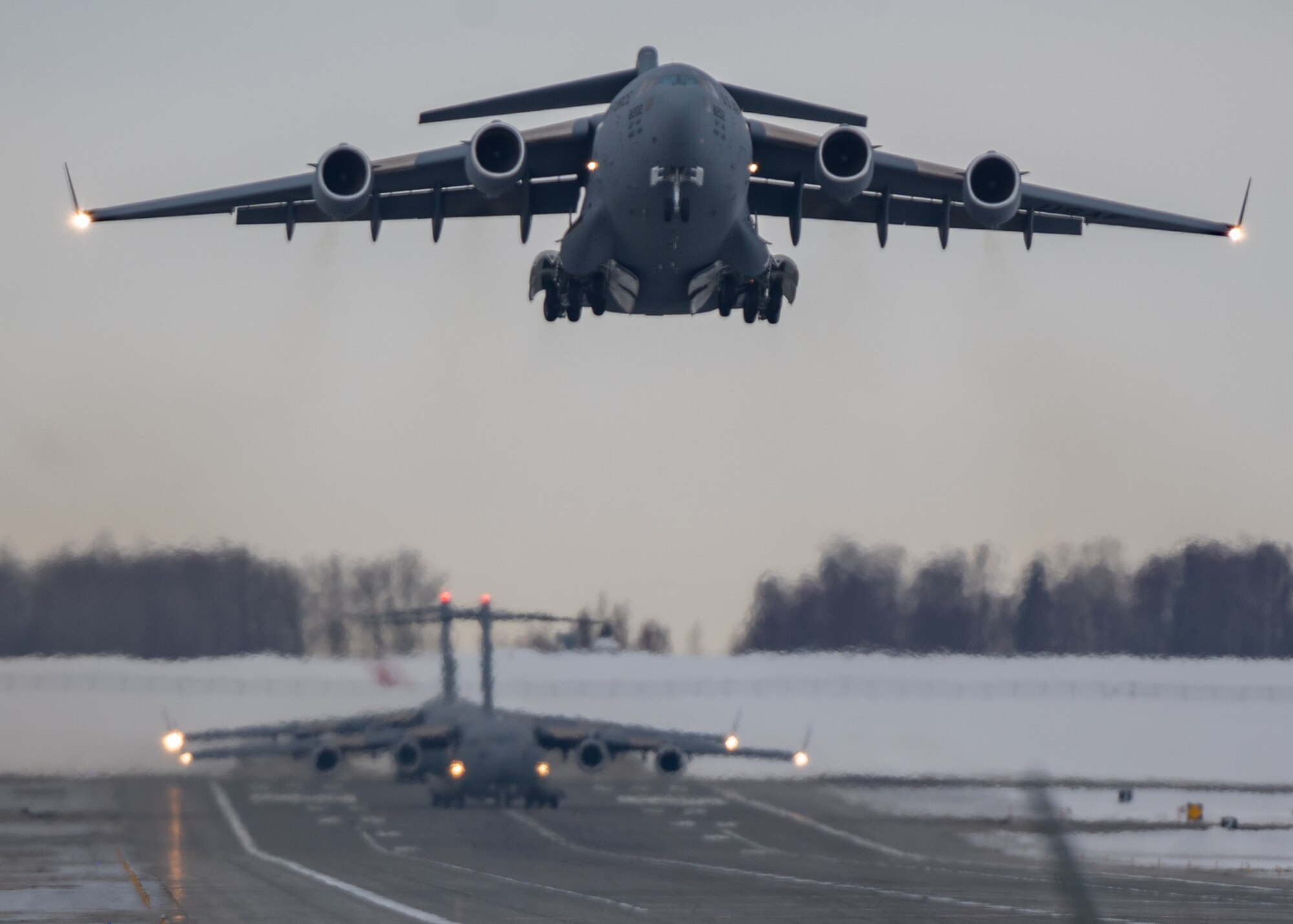 A C-17 Globemaster III assigned to Joint Base Lewis-McChord, Washington, takes off from a runway during Exercise Rainer War 22-A at Joint Base Elmendorf-Richardson, Alaska, March 18, 2022. The exercise is designed to demonstrate the wing’s ability to operate and survive while defeating challenges to the U.S. military advantage in all operating domains – air, land, sea and cyberspace. (U.S. Air Force photo by Airman 1st Class Charles Casner)