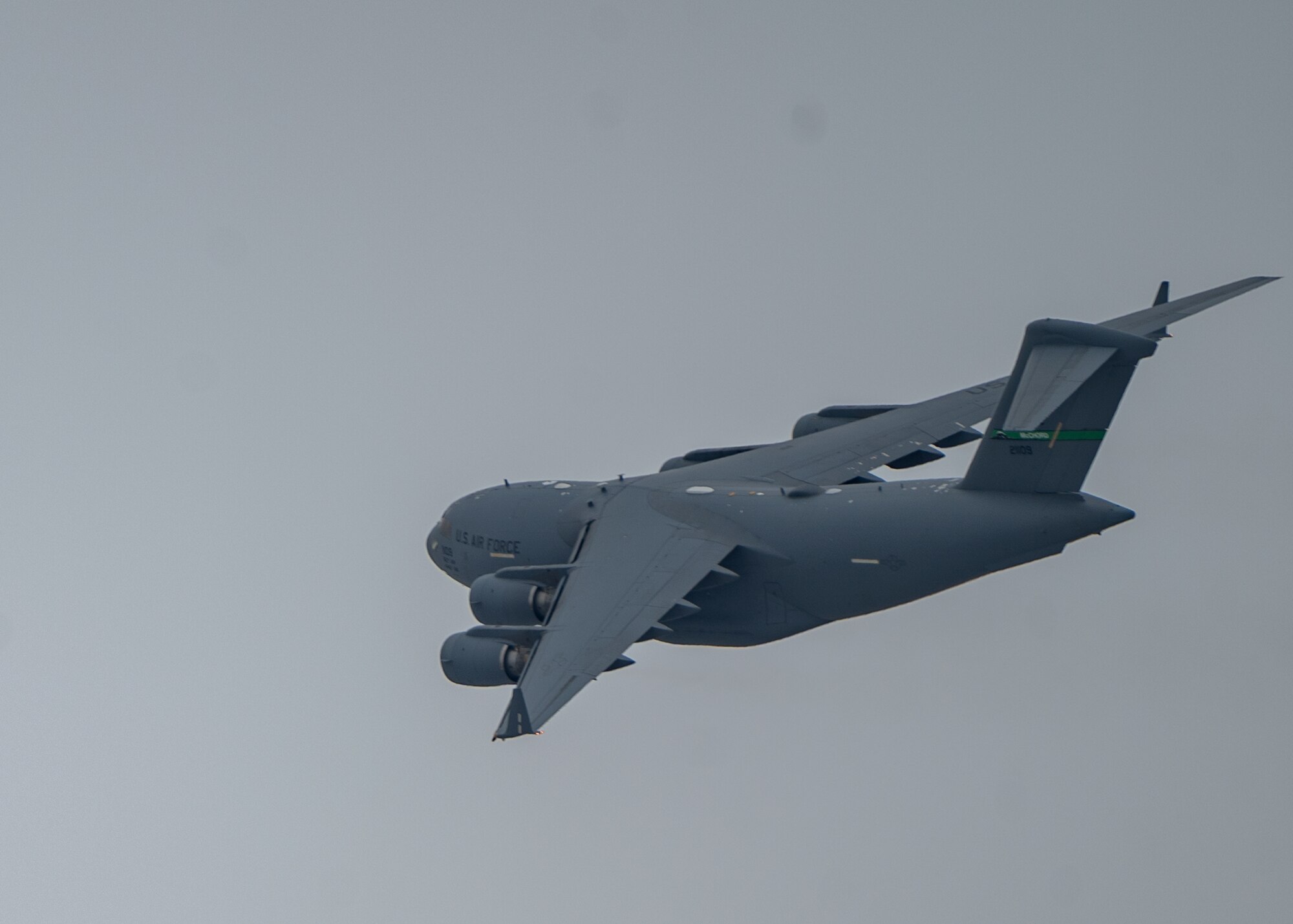 A C-17 Globemaster III assigned to Joint Base Lewis-McChord, Washington, flies over Joint Base Elmendorf-Richardson, Alaska, during Exercise Rainer War 22-A March 18, 2022. The exercise is designed to demonstrate the wing’s ability to operate and survive while defeating challenges to the U.S. military advantage in all operating domains – air, land, sea and cyberspace. (U.S. Air Force photo by Airman 1st Class Charles Casner)