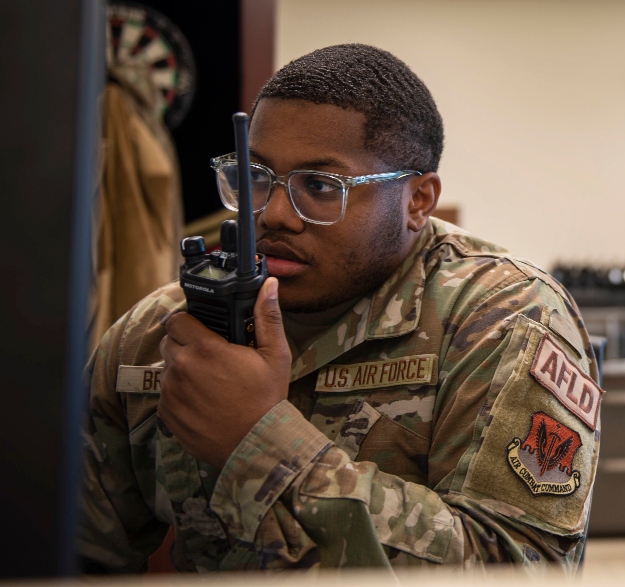 Senior Airman Dashaun Branch, 4th Operations Support Squadron airfield management shift lead, communicates with Airmen on the flightline at Seymour Johnson Air Force Base, North Carolina, March 17, 2022. Branch is responsible for networking with aircrew and ensuring there are no debris on the flight path, which aircraft use to land or depart. (U.S Air Force photo by Airman 1st Class Sabrina Fuller)