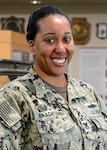 GULFPORT, Mississippi (March 21, 2022) - Logistics Specialist 1st Class Mary Bradford, assigned to the 22nd Naval Construction Regiment, smiles as she is photographed in her work space. Bradford recently shared her experiences dealing with depression and anxiety as a way to promote, raise awareness, and erase stigmas surrounding mental health. (Courtesy photo by Mr. Jeff Pierce)
