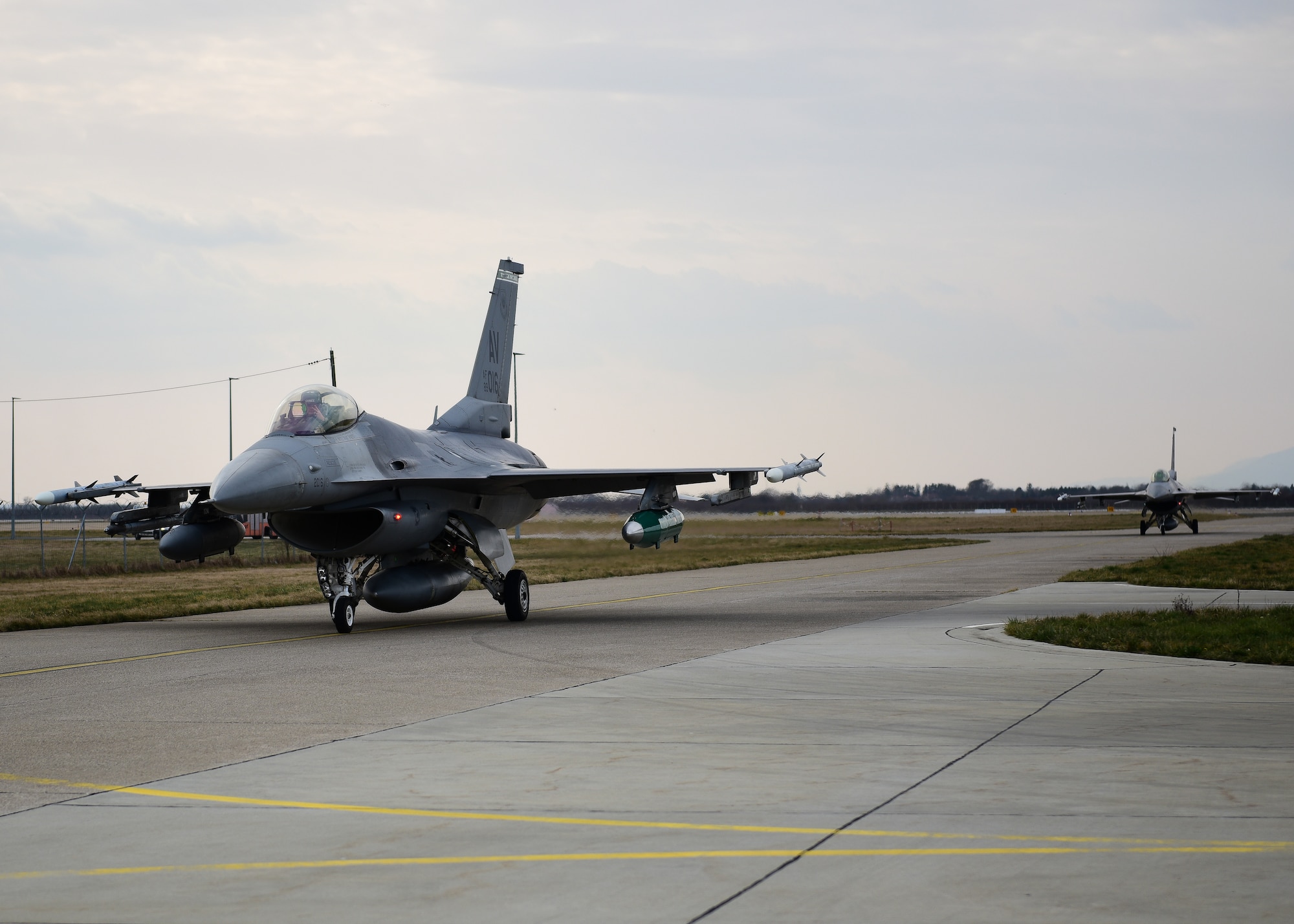 Two U.S. Air Force F-16C Fighting Falcon pilots assigned to the 555th Fighter Squadron from the 31st Fighter Wing, Aviano Air Base, Italy, taxi in after landing at Croatia’s 91st Air Base at Pleso, March 16, 2022. The 31st FW will execute routine Agile Combat Employment operations with Croatian Allies. Missions such as these enhance the readiness necessary to respond to any potential challenge in Southeast Europe. (U.S. Air Force photo by Tech. Sgt. Miquel Jordan)