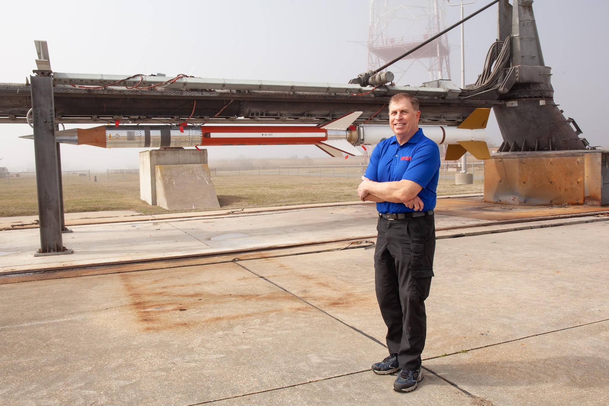 Fernando Santos, Wallops range project manager for BOLT II, with the BOLT II rocket on the pad. Photo by NASA/Wallops, Brian Bonsteel. NASA/Wallops photo/ Brian Bonsteel.