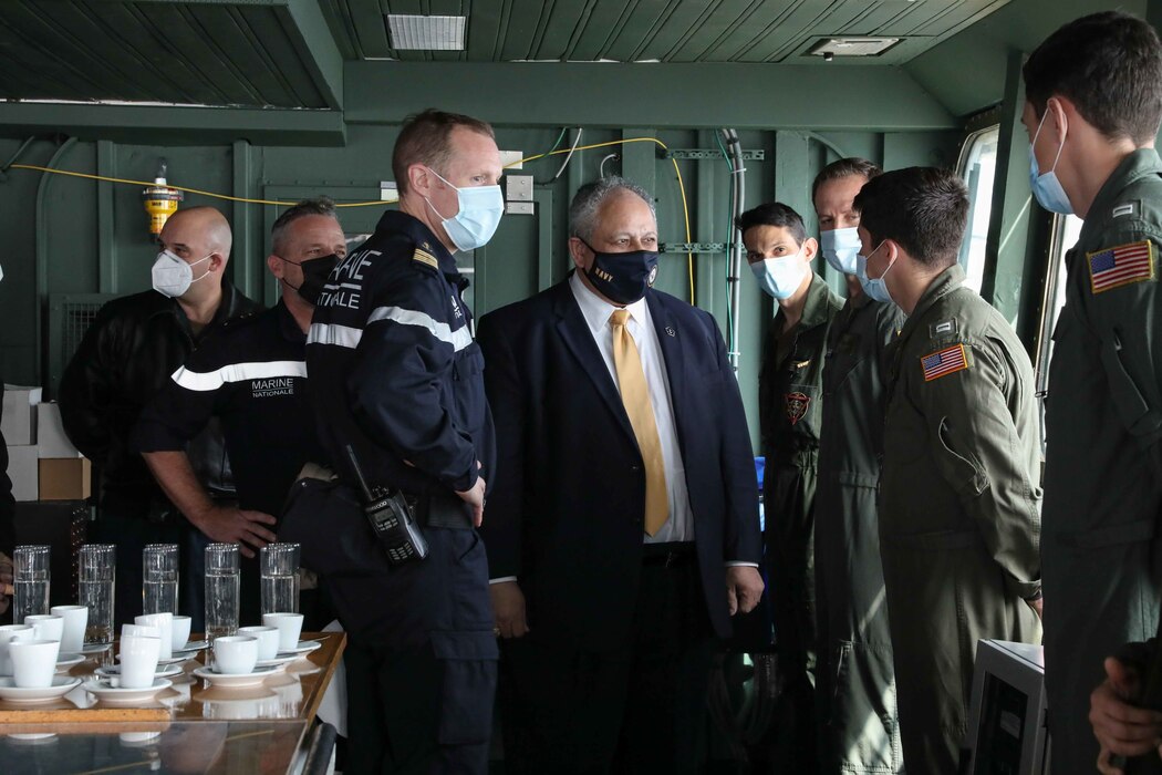 The Honorable Carlos del Toro, Secretary of the Navy, center, speaks with Sailors during a visit to the French aircraft carrier Charles de Gaulle (R 91)