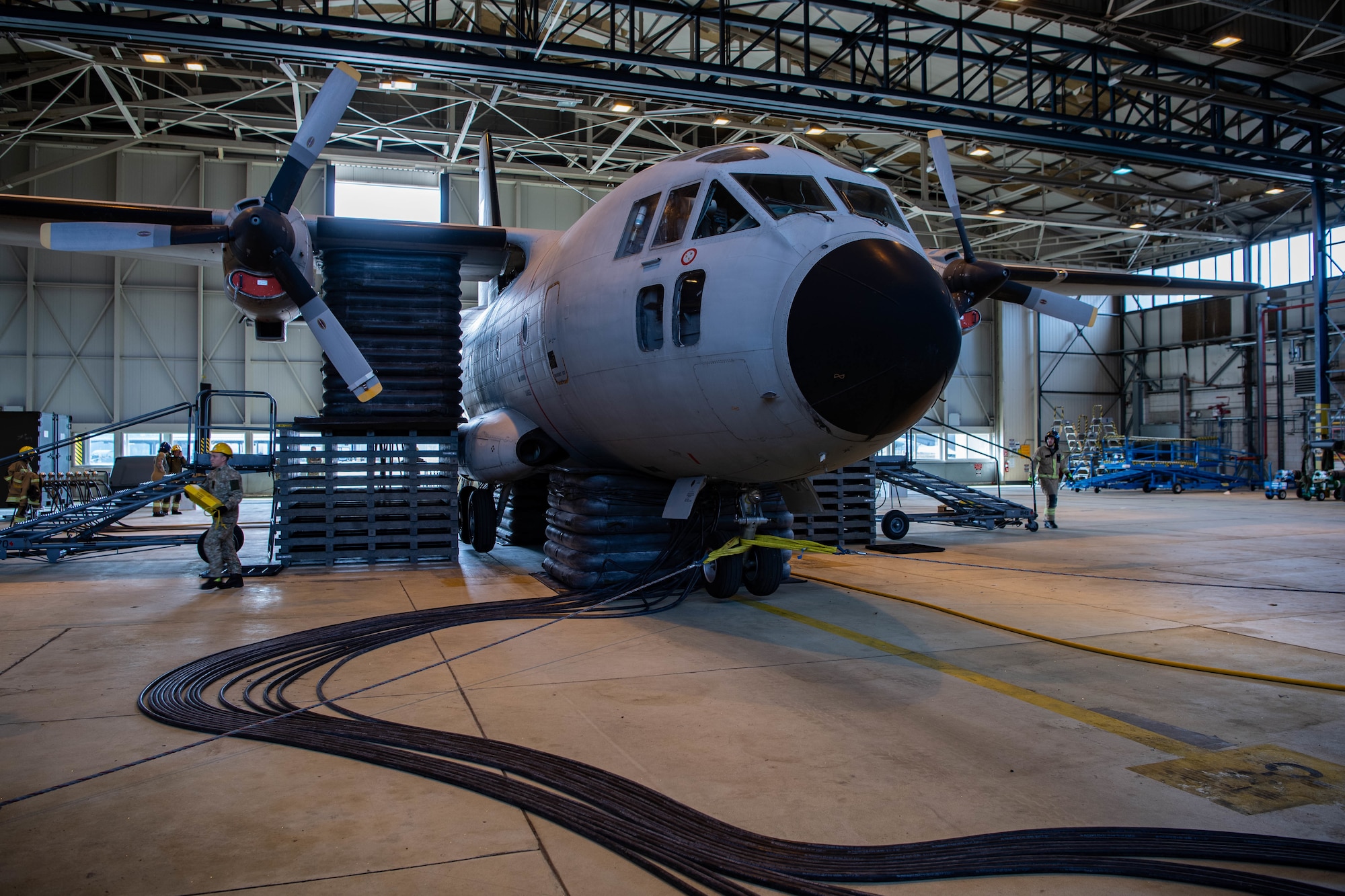 An aircraft is lifted in a hangar