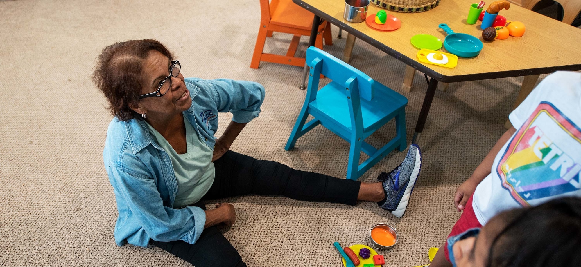 Woman plays with children