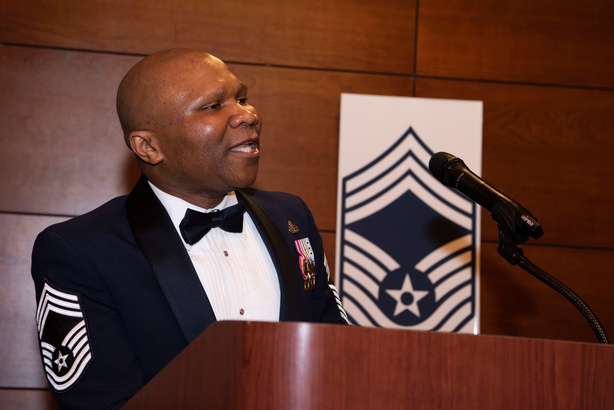 U.S. Air Force Chief Master Sgt. Azeez Oguntade, the 673d Force Support Squadron senior enlisted leader, speaks during an annual Chief Master Sergeant Induction ceremony at Joint Base Elmendorf-Richardson, Alaska. March 18, 2022. Honoring seven enlisted leaders from across the 3rd Wing and 673d Air Base Wing, leadership recognized the Airmen’s promotion to the ninth and highest enlisted rank in the U.S. Air Force. With the rank being created in 1959, only one percent of the total enlisted force can hold the rank of chief master sergeant at a given time. (U.S. Air Force photo by Senior Airman Emily Farnsworth)