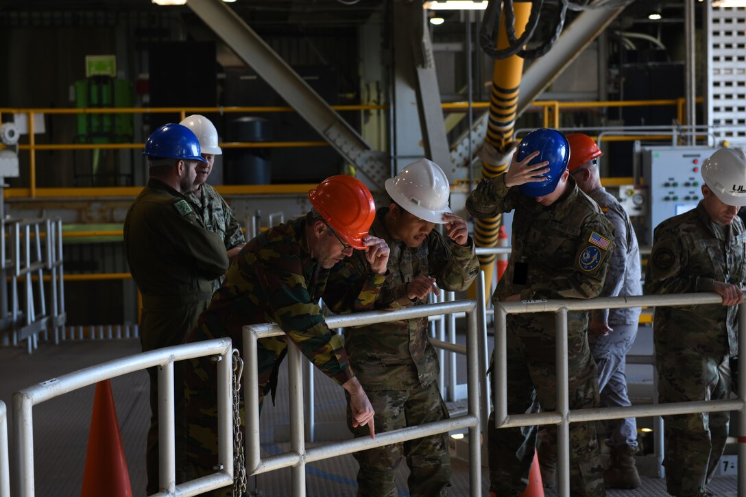 Members of the Air War College, along with tour guides from the 2nd Space Launch Squadron, look down 14 floors through the loading area for rockets at Space Launch Complex 6 on Vandenberg Space Force Base, Calif., March 14, 2022. Officers from 21 different nations visited Vandenberg to get familiarized with combined space operations and what challenges, concerns, and opportunities they bring. (U.S. Space Force photo by Airman 1st Class Ryan Quijas)