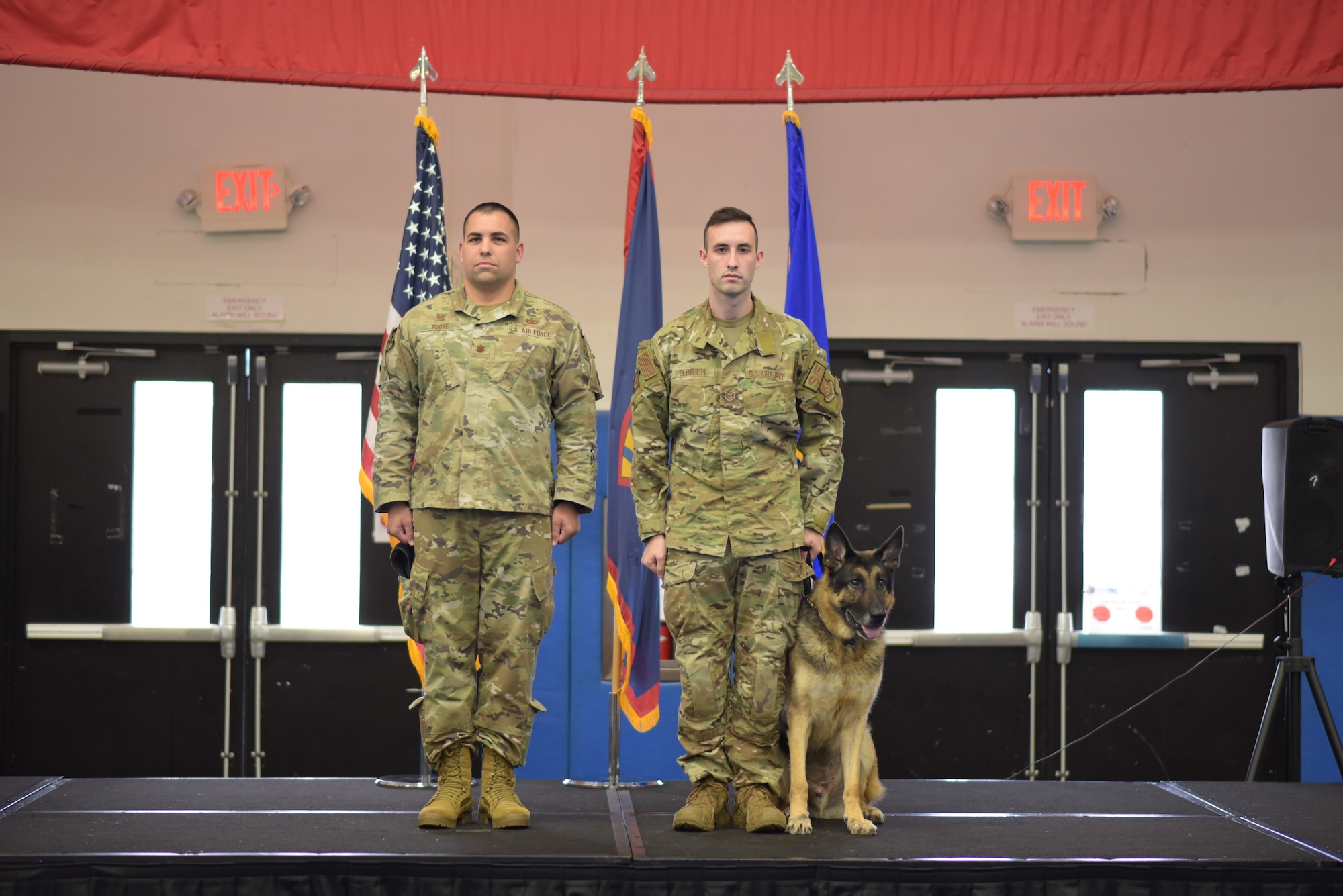 U.S. Air Force Staff Sgt. Alexander O'Brien, 36th Security Forces Squadron Military Working Dog handler, escorts MWD Pedro during a retirement ceremony at Andersen Air Force Base, Guam on March 23, 2022. The ceremony recognized four MWD's with a combined 29 years of service. (U.S. Air Force photo by Airman 1st Class Emily Saxton)