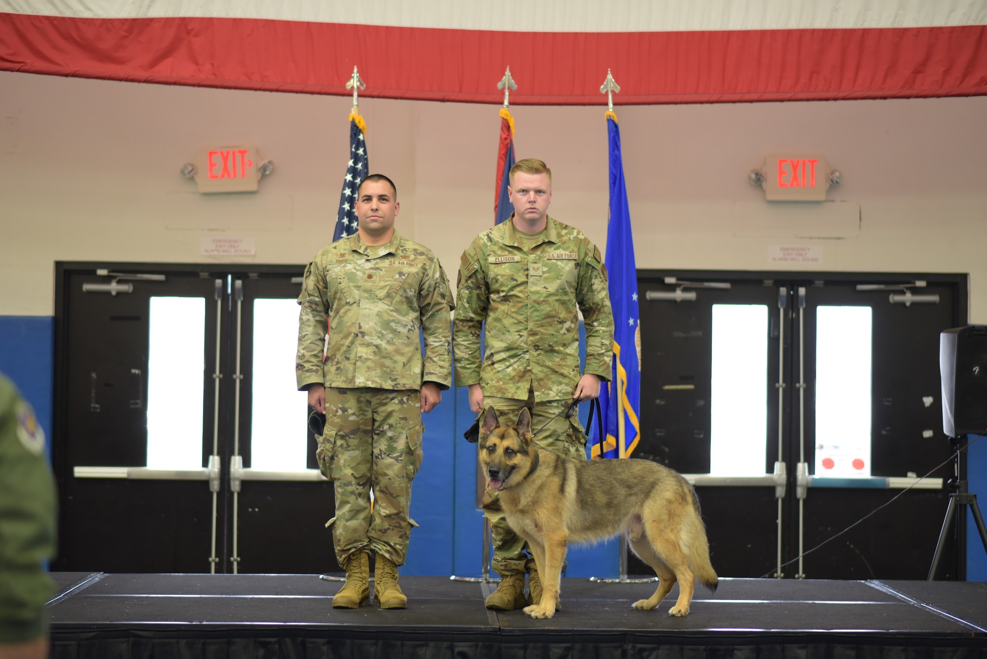 U.S. Air Force Staff Sgt. Matthew Ellison, 36th Security Forces Squadron Military Working Dog handler, escorts MWD Johnny during a retirement ceremony at Andersen Air Force Base, Guam on March 23, 2022. The ceremony recognized four MWD's with a combined 29 years of service. (U.S. Air Force photo by Airman 1st Class Emily Saxton)