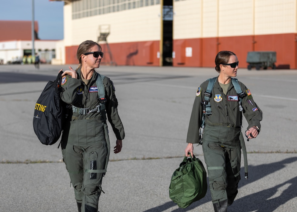 Jess Peterson, 412th Operations Group Technical Director, and Caroline White, 412th Operations Group Standards and Evaluations Deputy Chief and T-38 Talon pilot, walk on the flightline prior to a training sortie at Edwards Air Force Base, California, March 3. (Air Force photo by Bryce Bennett)