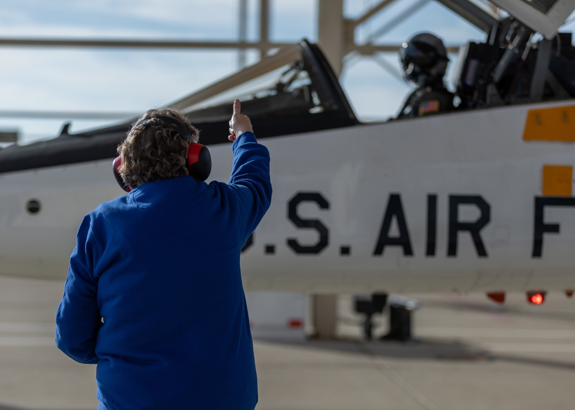 Anitta Schumacher, 412th Aircraft Maintenance Squadron T-38 Crew Chief, gives the thumbs up to Caroline White, 412th Operations Group Standards and Evaluations Deputy Chief, as she prepares to conduct a training sortie from Edwards Air Force Base, California, March 3. (Air Force photo by Bryce Bennett)