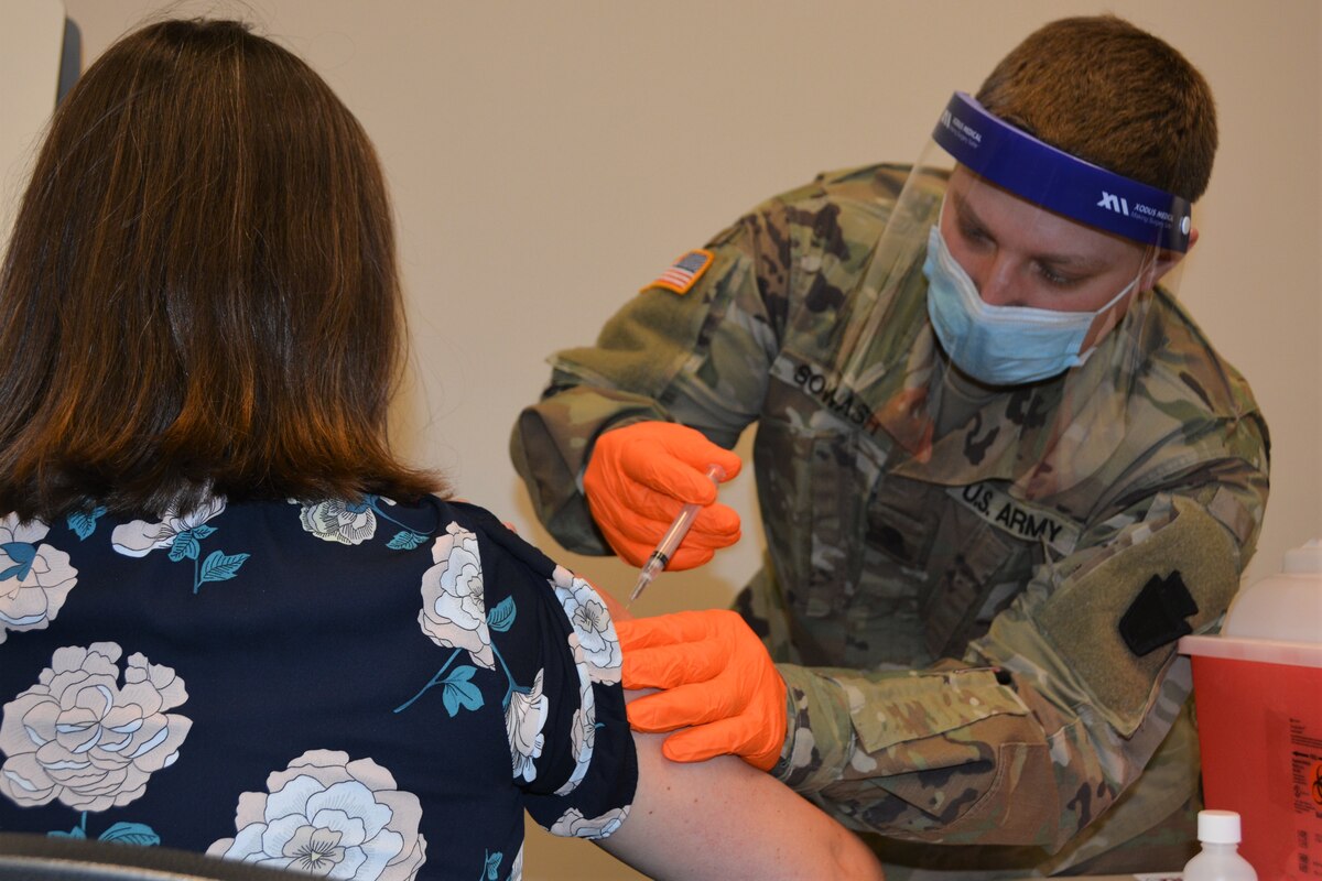 Spc. Gary Sowash, a combat medic with Headquarters and Headquarters Company, 2/112th Infantry Regiment, Pennsylvania National Guard, administers a COVID-19 vaccine at Lancaster-Lebanon IU13 in Lancaster, March 12, 2021. After two years and hundreds of missions across the commonwealth, the Pennsylvania National Guard ended its COVID-19 response March 16, 2022.
