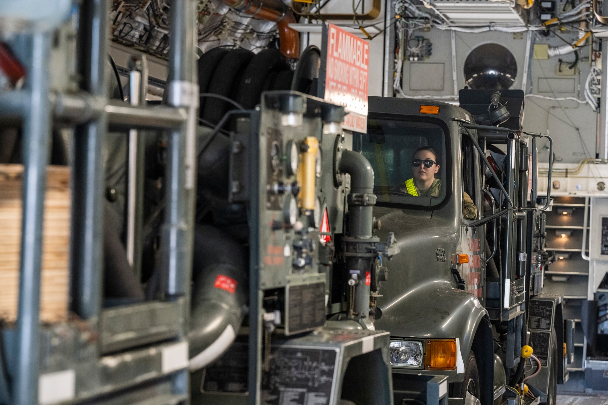 U.S. Air Force Airman 1st Class Molly Odovich, 509th Logistics Readiness Squadron fuels distribution operator, prepares to offload a fuel truck from a C-17 Globemaster at Royal Australian Air Force Base Amberley, Aus., March 22, 2022. Airmen from Whiteman Air Force Base, Missouri were in Australia to assist a B-2 training mission in support of Pacific Air Forces' training efforts with allies and partners in support of a free and open Indo-Pacific region. (U.S. Air Force photo by Tech. Sgt. Hailey Haux)