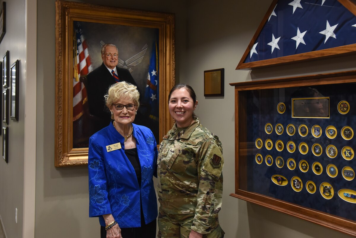 Dr. Lucy Greene, left, stands with U.S. Air Force Staff Sgt. Kyana Mamahua, 74th Fighter Squadron intelligence noncommissioned officer in charge, right, in front of a portrait of Parker Greene after Mamahua was presented the 2021 Parker and Dr. Lucy Greene Service Award, March 8, 2022, at Moody Air Force Base, Georgia. The award was inspired by the Greene’s consistent community service. (U.S. Air Force photo by 1st Lt. Christian Little)