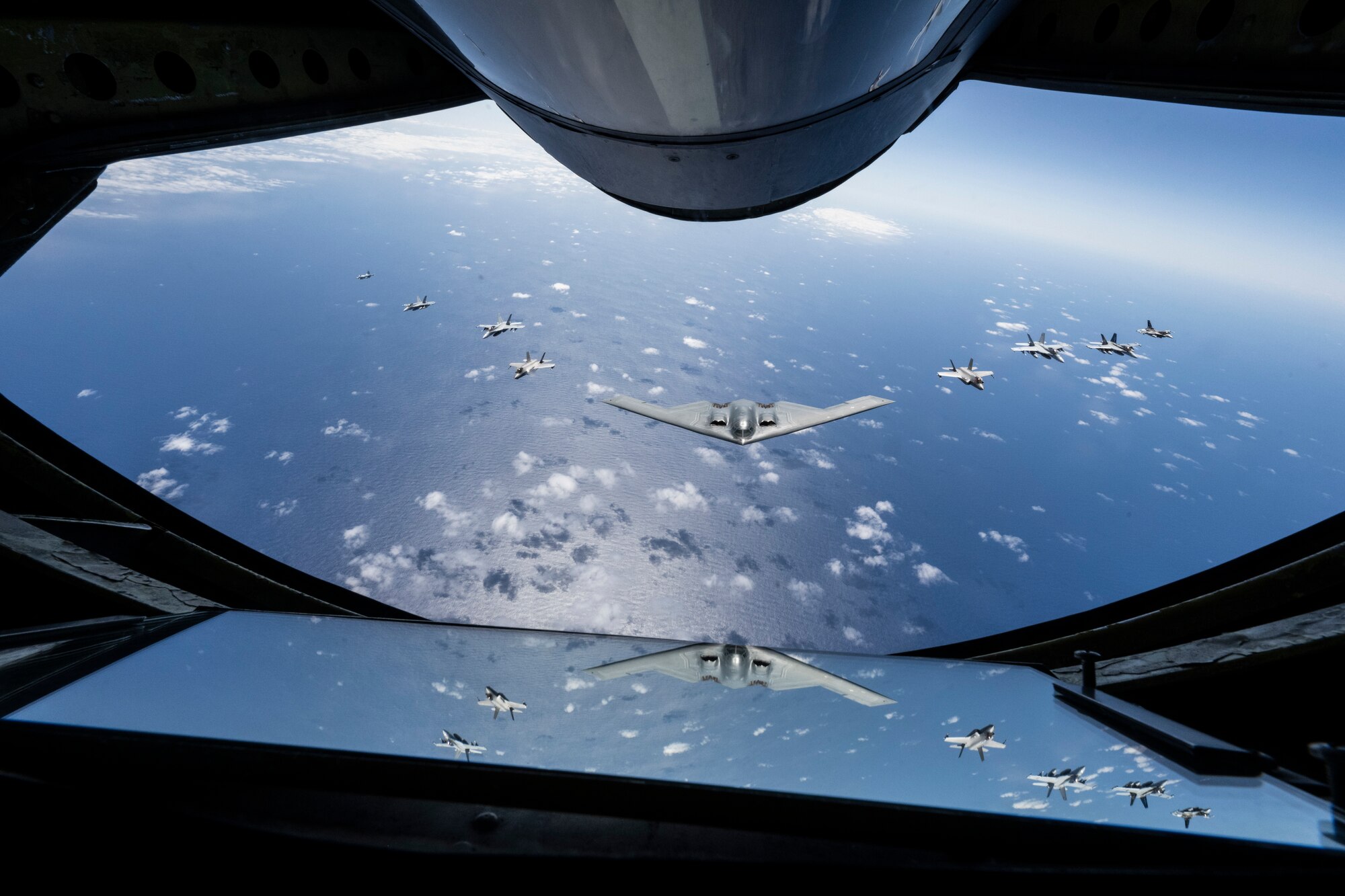 A U.S. Air force B-2 Spirit from Whiteman Air Force Base, Missouri, flies in formation with two Royal Australian Air Force F-35A Lightning IIs, two RAAF F/A-18F Super Hornets, two RAAF EA-18 Growlers, and two U.S. Air Force F-16C Aggressors from Eielson Air Force Base, Alaska during a training mission in the Indo-Pacific region, March 23, 2022. The mission provided the opportunity to train and work with our allies and partners in joint and coalition operations and exercises. (U.S. Air Force photo by Tech. Sgt. Hailey Haux)