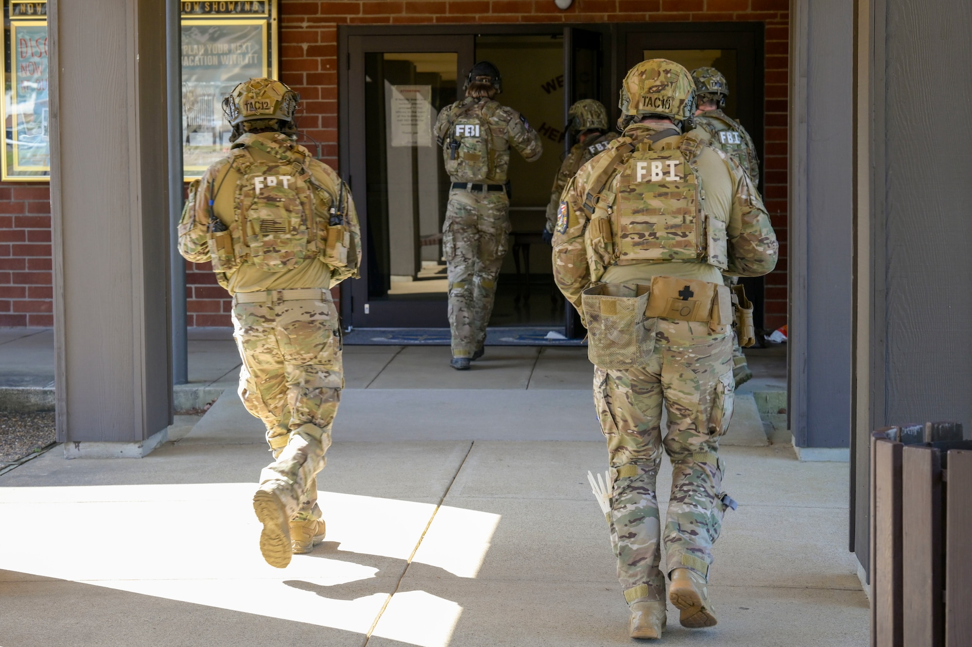 Members of the Federal Bureau of Investigation SWAT team prepare to enter a building