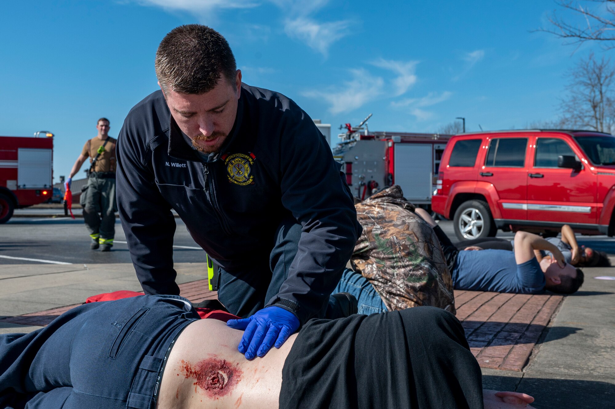 A first responder with the Jacksonville Fire Department assess a patient’s injury