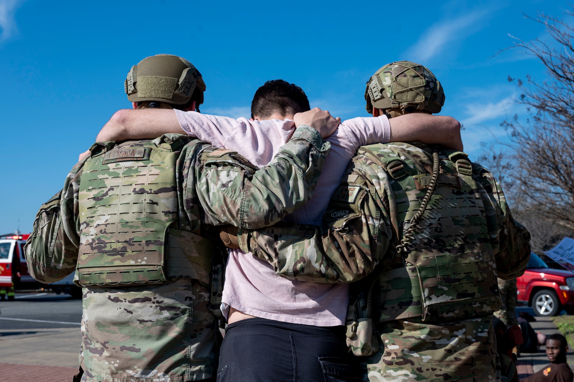 Airmen assigned to the 19th Security Forces Squadron escort a man to medical services