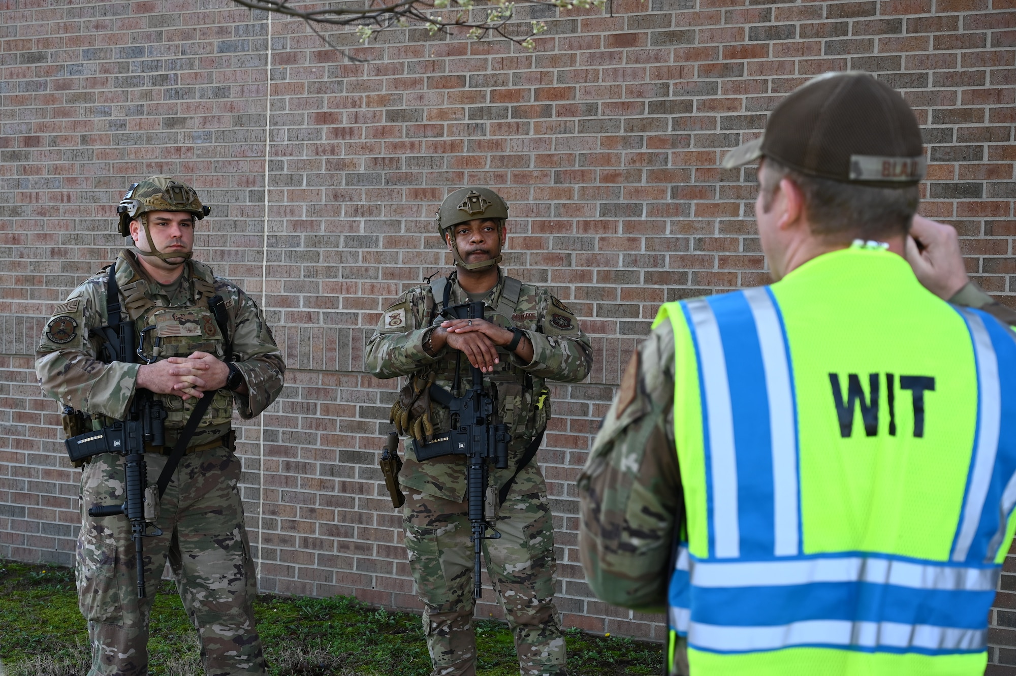 Airmen assigned to the 19th Security Forces Squadron have a discussion with a member of the Wing Inspection Team