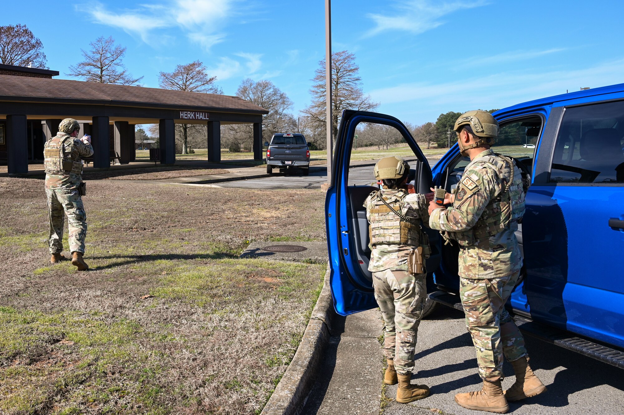 Airmen assigned to the 19th Security Forces Squadron secure the perimeter of a building