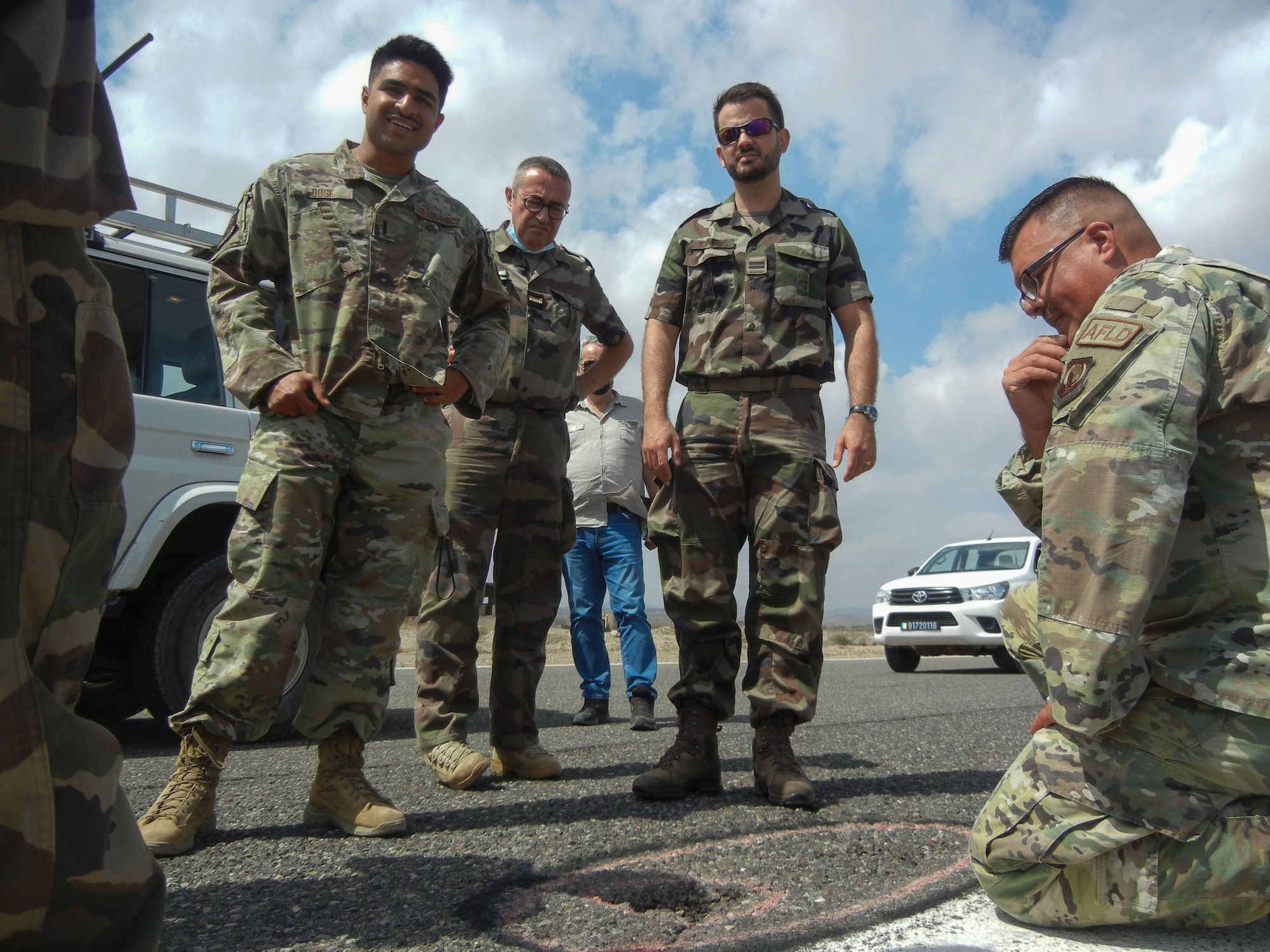 Airmen from the 776th Expeditionary Air Base Squadron airfield operations flight hosted members from the French military to discuss runway repairs at Chabelley Airfield (CADJ), Djibouti, March 10, 2022. As a part of a trilateral agreement, CADJ is a French installation operated by the United States in the country of Djibouti demonstrating the various partnerships and alliances the U.S. relies on to strengthen defense institutions and counter a multitude of threats to ensure a more stable, prosperous Africa. (U.S. Air Force courtesy photo by Tech. Sgt. Joel Yerk