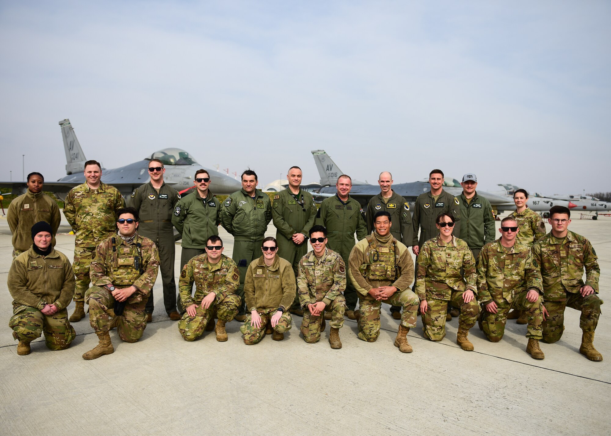 Members of the 31st Fighter Wing, Aviano Air Base, Italy, pose for a photo with members of the 191st Fighter Squadron from the Croatian Air Force in front of two U.S. Air Force F-16C Fighting Falcons and Croatian MiG-21s during the conclusion of Agile Combat Employment operations at Croatia’s 91st Air Base at Pleso, March 17, 2022. The 31st FW executed routine ACE operations with Croatian Allies in a mission to enhance the readiness necessary to respond to any potential challenge in Southeast Europe. (U.S. Air Force photo by Tech. Sgt. Miquel Jordan)