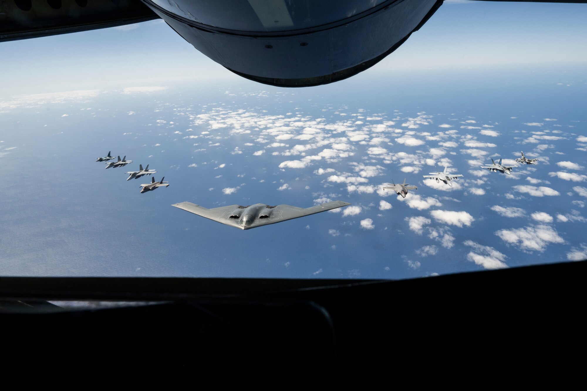 A U.S. Air force B-2 Spirit from Whiteman Air Force Base, Missouri, flies in formation with two Royal Australian Air Force F-35A Lightning IIs, two RAAF F/A-18F Super Hornets, two RAAF EA-18 Growlers, and two U.S. Air Force F-16C Aggressors from Eielson Air Force Base, Alaska during a training mission in the Indo-Pacific region, March 23, 2022. During the more than 50-hour round-trip trek to Australia and back, the B-2 received aerial refueling from numerous tanker aircraft—ensuring the mission was successful and further demonstrating the U.S. Air Forces’ global strike capabilities. (U.S. Air Force photo by Tech. Sgt. Hailey Haux)