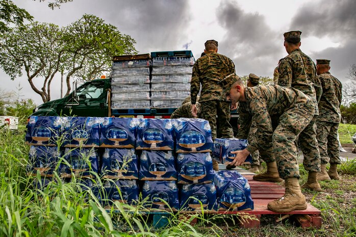 U.S. Marines with Combat Logistic Battalion 3, 3rd Marine Logistics Group, unload pallets of bottled water at a water distribution point, Manana Housing Community, Pearl City, Hawaii, Dec. 14, 2021. U.S. Marines with 3rd MLG, as part of Task Force KULEANA, and soldiers with 1st Cavalry Division, are providing support services such as drinking water, field expedient showers and laundry facilities to the residents of Joint Base Pearl Harbor-Hickam affected by the ongoing water issue. 3rd MLG, based out of Okinawa, Japan, is a forward deployed combat unit that serves as III Marine Expeditionary Force’s comprehensive logistics and combat service support backbone for operations throughout the Indo-Pacific area of responsibility.
