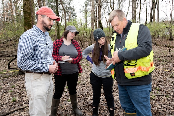 (Left to Right) Ben MacIntyre, biologist in the U.S. Army Corps of Engineers Nashville District Regulatory Division’s Western Branch, Sammy Iskrzycki, biologist in the Regulatory Division Western Branch, Katie Alston, biologist in the Regulatory Division Technical Services Branch, and Mark G. McIntosh, project manager in the Regulatory Division Technical Services Branch, check for hydrology indicators at a soil point on a vegetation plot March 18, 2022, while training near J. Percy Priest Lake in Nashville, Tennessee. They support regulatory permitting actions at the U.S. Army Corps of Engineers Nashville District Regulatory Division. (USACE Photo by Lee Roberts)