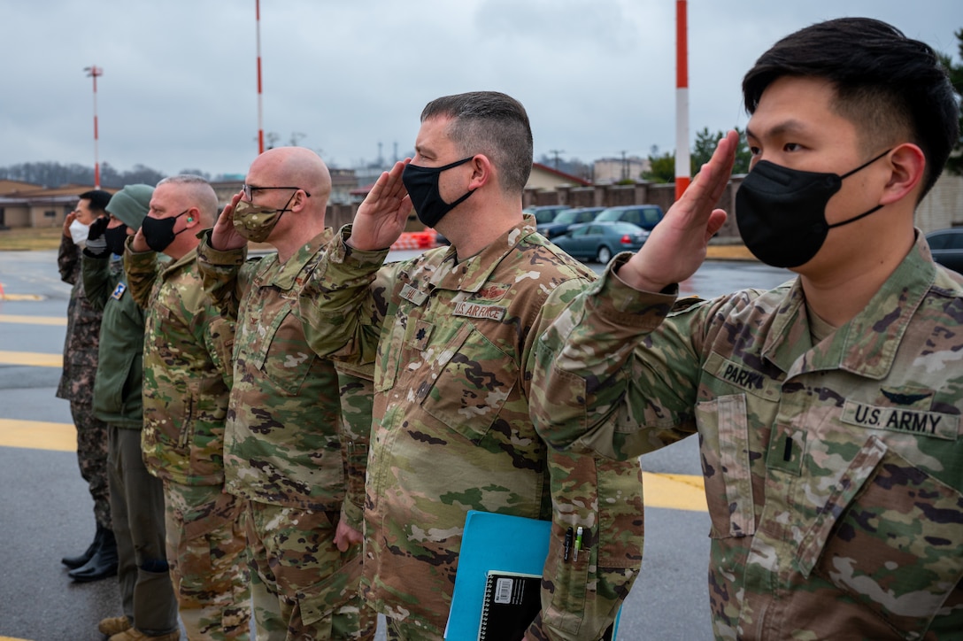 Top military leaders of Osan Air Base, Republic of Korea, render a salute to greet U.S. Army Gen. James H. Dickinson, U.S. Space Command commander’s arrival on March 19, 2022.