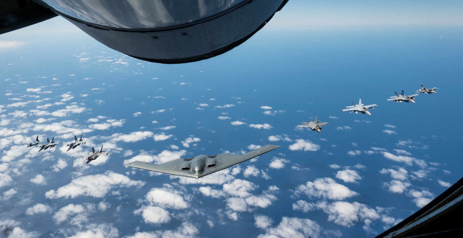 A U.S. Air force B-2 Spirit from Whiteman Air Force Base, Missouri, flies in formation with two Royal Australian Air Force F-35A Lightning IIs, two RAAF F/A-18F Super Hornets, two RAAF EA-18 Growlers, and two U.S. Air Force F-16C Aggressors from Eielson Air Force Base, Alaska during a training mission in the Indo-Pacific region, March 23, 2022. Once in Australian airspace, the B-2 crews from the 509th Bomb Wing teamed up with a KC-135 Stratotanker from the Alaska Air National Guard to complete aerial refueling before integrating with the eight fighter aircraft. (U.S. Air Force photo by Tech. Sgt. Hailey Haux)