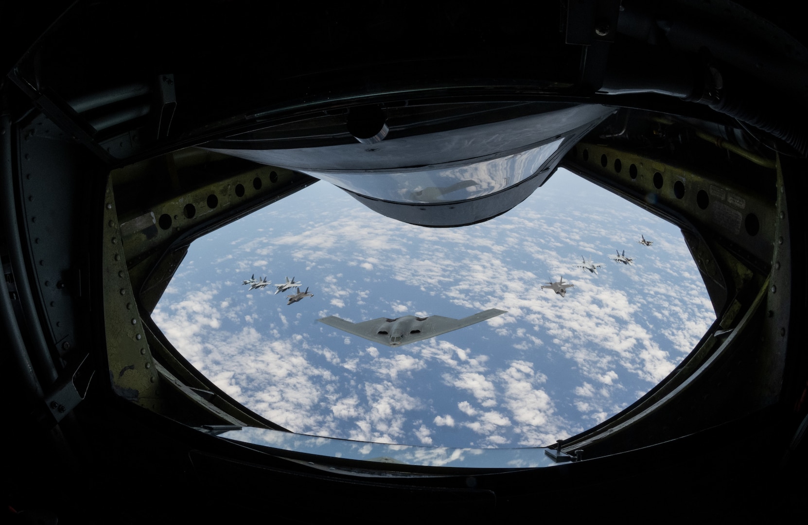 A U.S. Air force B-2 Spirit from Whiteman Air Force Base, Missouri, flies in formation with two Royal Australian Air Force F-35A Lightning IIs, two RAAF F/A-18F Super Hornets, two RAAF EA-18 Growlers, and two U.S. Air Force F-16C Aggressors from Eielson Air Force Base, Alaska during a training mission in the Indo-Pacific region, March 23, 2022. This mission was conducted to support Pacific Air Forces' training efforts with allies and partners in support of a free and open Indo-Pacific. (U.S. Air Force photo by Tech. Sgt. Hailey Haux)