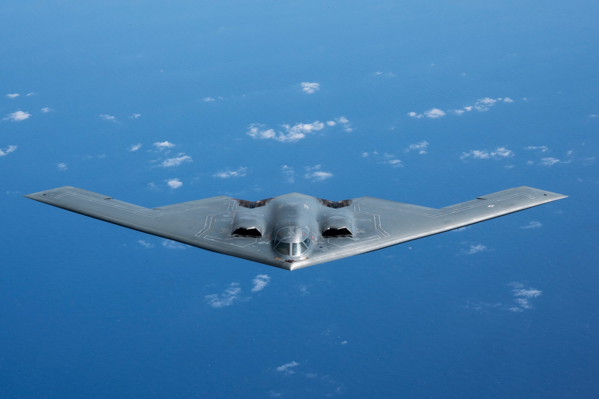 A B-2 Spirit from Whiteman Air Force Base, Missouri, flies alongside a KC-135 Stratotanker from the Alaska Air National Guard during a training mission with the Royal Australian Air Force in the Indo-Pacific region, March 23, 2022. (U.S. Air Force photo by Tech. Sgt. Hailey Haux)