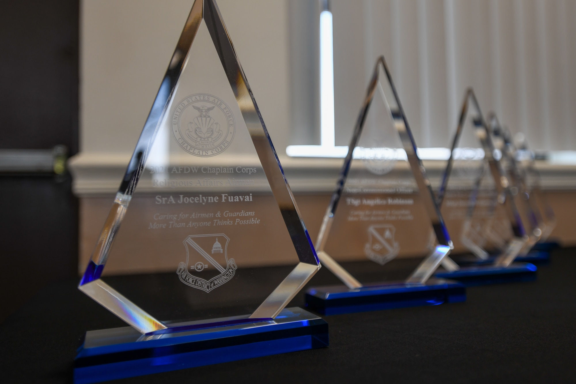 Mementos from the Air Force District of Washington Chaplain Corps sit in a row during the 2021 AFDW Chaplain Corps Award ceremony in Chapel 1 on Joint Base Andrews, Md., March 22, 2022.