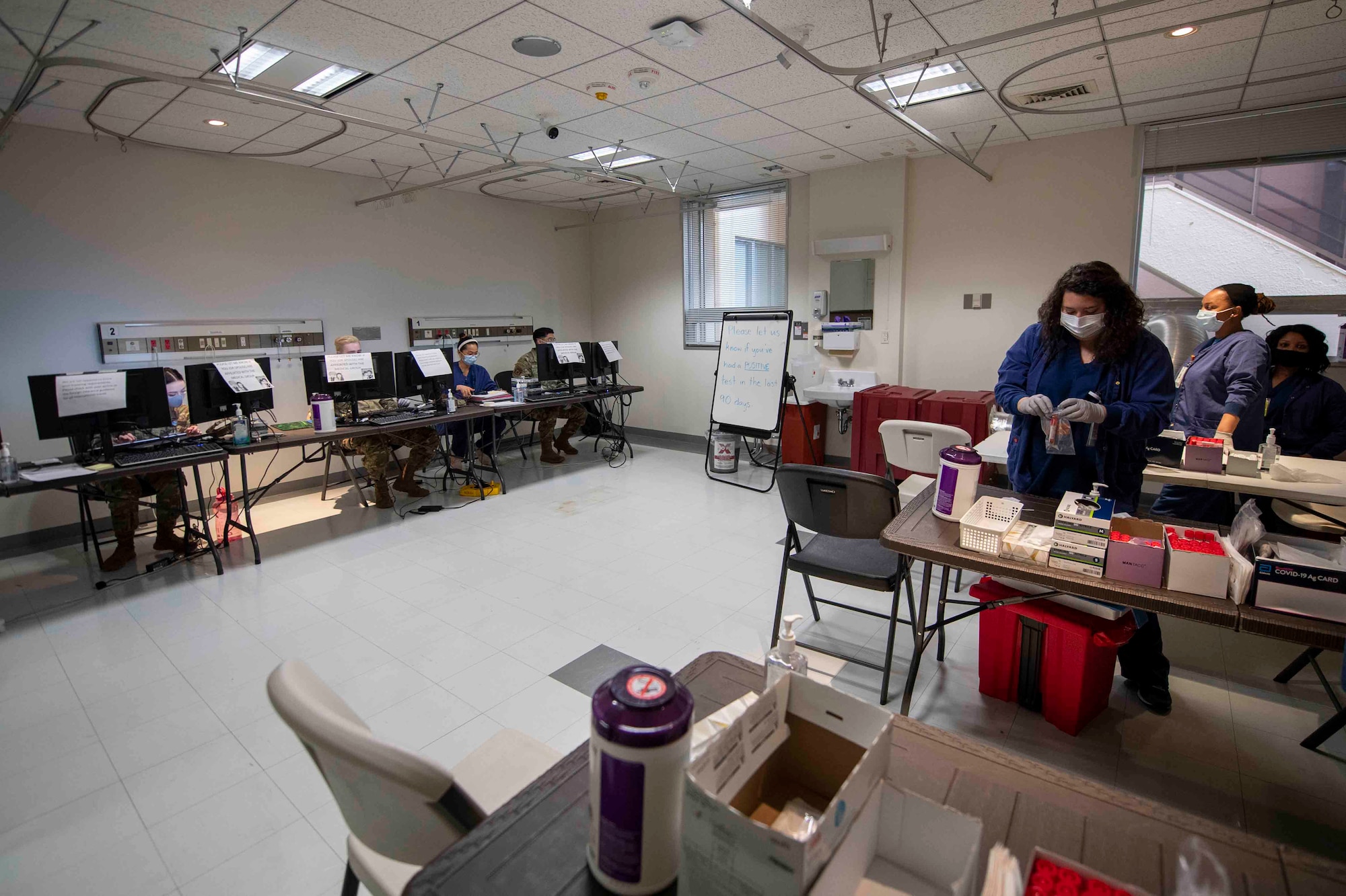 The 374th Medical Group COVID-19 Response Team members prepare the latest rapid antigen tests at the new COVID Testing center, recently relocated inside the base hospital building at Yokota Air Base, Japan, March 22, 2022.
