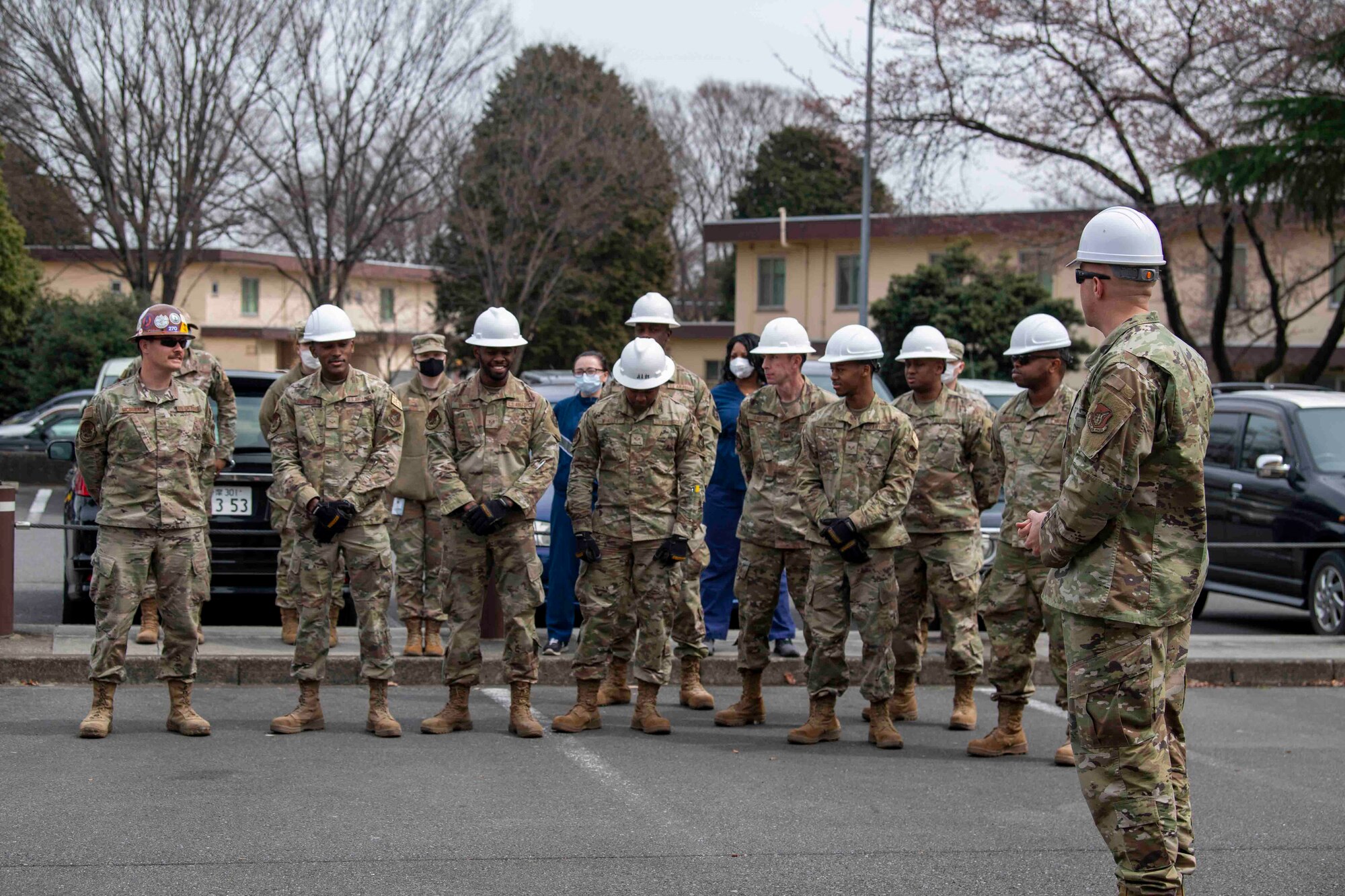 Senior Master Sgt. Charles Patterson, right, 374th Civil Engineer Squadron operations flight superintendent, briefs deployed Airmen from the 117th CES, Sumpter Smith Joint National Guard Base, Alabama, and the 908th CES, Maxwell Air Force Base, Alabama, prior to dismantling the base’s former COVID-19 screening tent at Yokota Air Base, Japan, March 23, 2022.