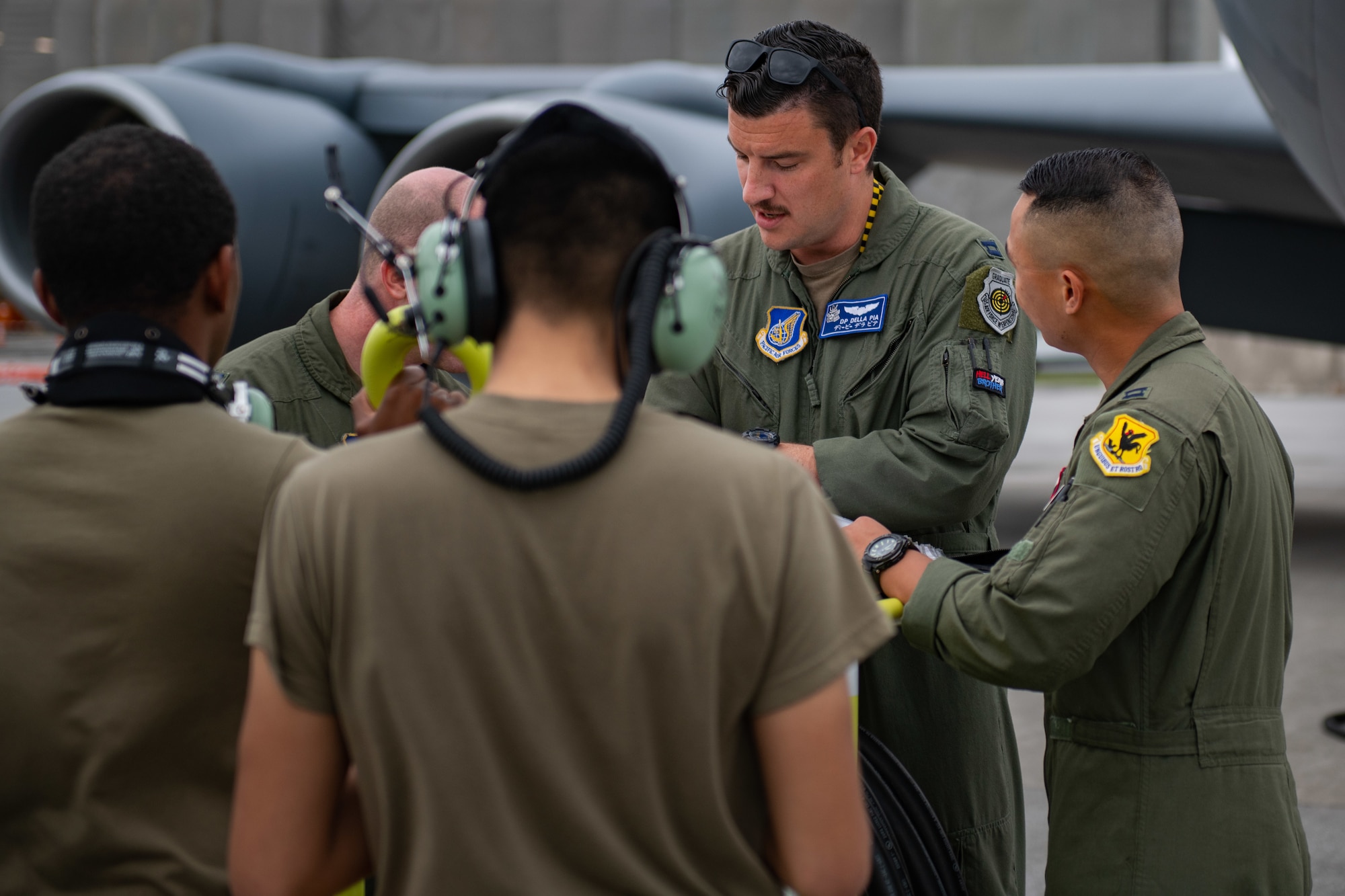 A group of airmen huddle up to discuss plans for the day