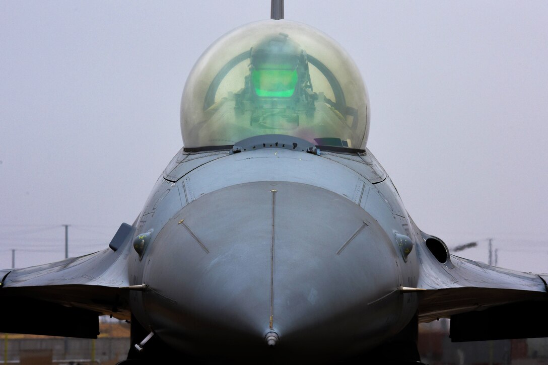 A pilot sitting in an airplane prepares for takeoff.