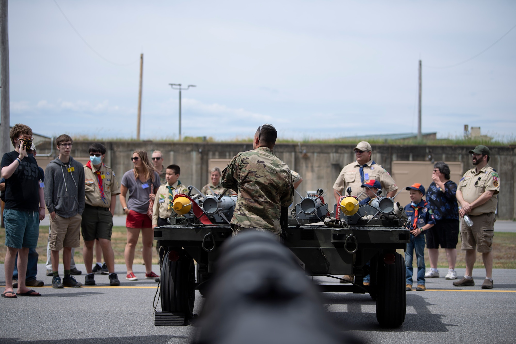 Photo of children from a local scout group, along with civilians, looking into a munitions bunker at the Vermont Air National Guard Base in South Burlington, Vermont.