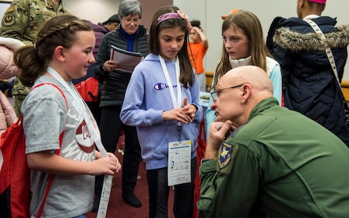 Gen. Arnold W. Bunch, Jr., Air Force Materiel Command commander, listens intently while talking to a group of girls during the Big Hoopla STEM Challenge, March 13, 2022, at the Dayton Convention Center, Ohio. The goal of the event was to tie together the excitement of college basketball and the power of STEM education. (U.S. Air Force photo by Jaima Fogg)