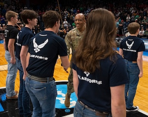 Senior Airman McKinley Gillis, Wright-Patterson Air Force Base guardsman, laughs with Col. Patrick Miller, 88th Air Base Wing and Wright-Patterson Air Force Base commander, March 16, 2022, prior to the honor guard taking part in the opening ceremony of the NCAA men’s basketball tournament First Four game between Wright State and Bryant. The base was also represented in the opening ceremony by a group of Airmen unfurling a large American flag. (U.S. Air Force photo by R.J. Oriez)