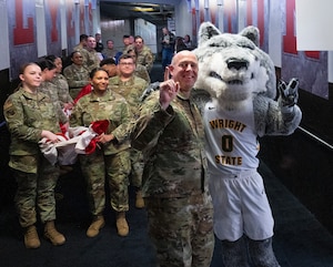 Senior Airman McKinley Gillis, Wright-Patterson Air Force Base guardsman, laughs with Col. Patrick Miller, 88th Air Base Wing and Wright-Patterson Air Force Base commander, March 16, 2022, prior to the honor guard taking part in the opening ceremony of the NCAA men’s basketball tournament First Four game between Wright State and Bryant. The base was also represented in the opening ceremony by a group of Airmen unfurling a large American flag. (U.S. Air Force photo by R.J. Oriez)