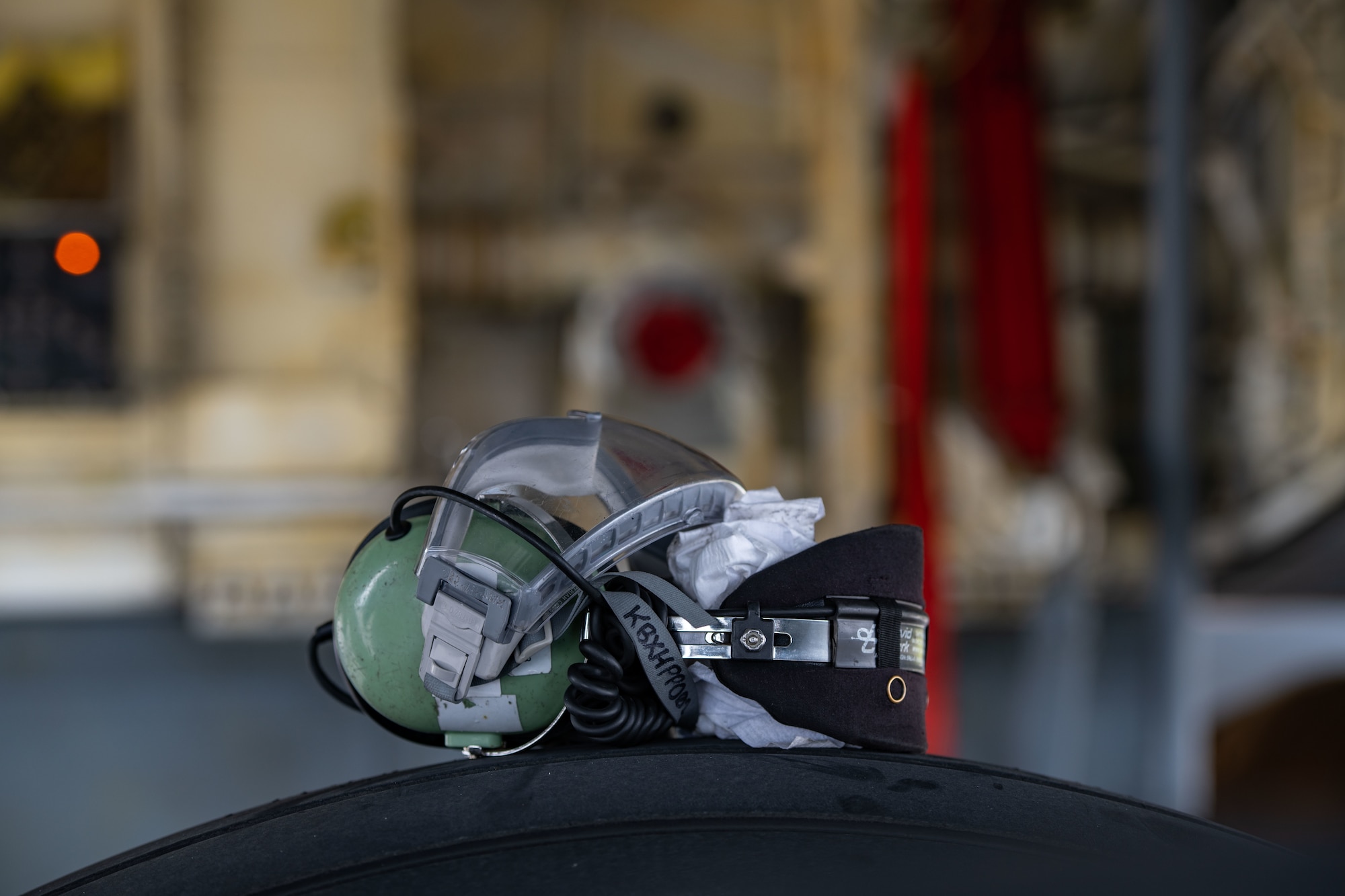 A set of goggles and ear protection sit on the wheel of a KC-135