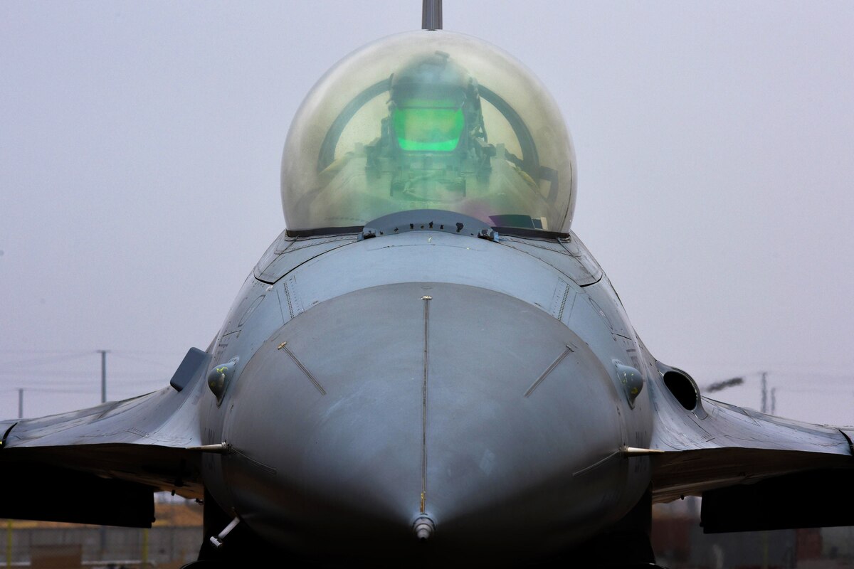A pilot sitting in an airplane prepares for takeoff.