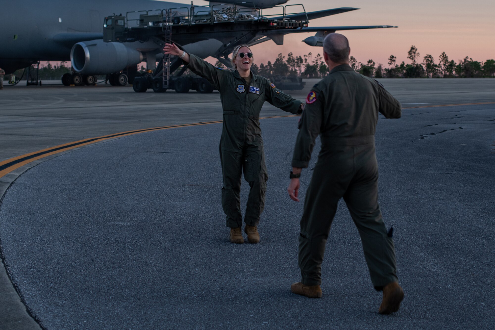 man and woman greet each other on flight line