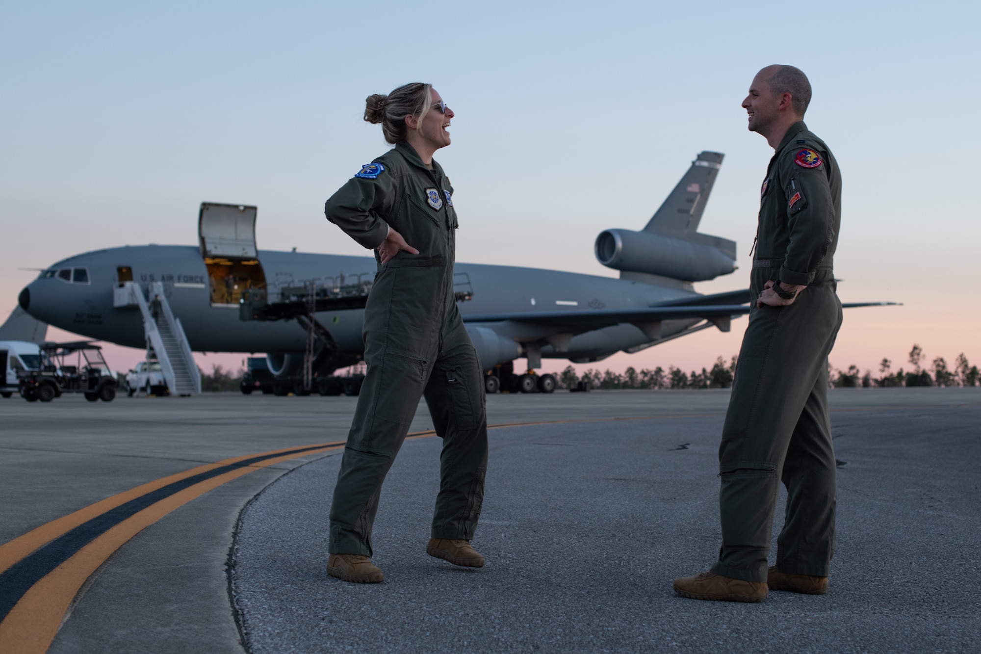 man and woman talk on flight line