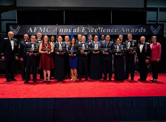 Winners of the Air Force Materiel Command Annual Excellence Awards pose with AFMC leadership at the end of the ceremony, March 23, 2022, at the Nation Museum of the U.S. Air Force at Wright-Patterson Air Force Base, Ohio. Airmen, military and civilian, from AFMC centers around the Air Force competed in 17 categories to be named the top Airman and to go on to compete at the Air Force level.  (U.S. Air Force photo by R.J. Oriez)