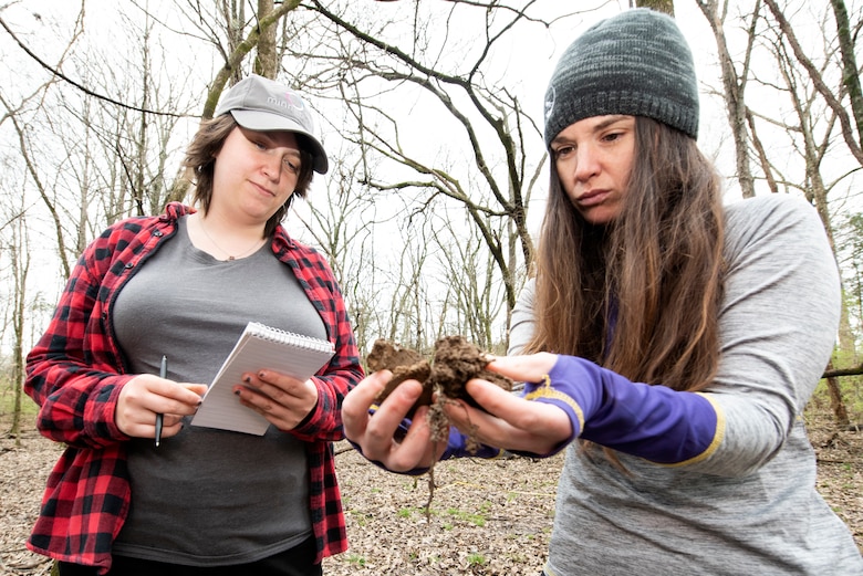 Sammy Iskrzycki (Left), biologist in the U.S. Army Corps of Engineers Nashville District Regulatory Division Western Branch, and Katie Alston, biologist in the Regulatory Division Technical Services Branch, check for hydrology indicators at a soil point on a vegetation plot March 18, 2022, while training near J. Percy Priest Lake in Nashville, Tennessee. (USACE Photo by Lee Roberts)