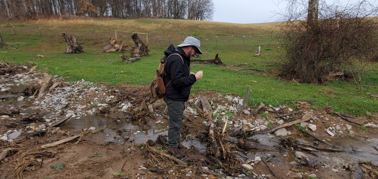 Ryan Evans, U.S. Army Corps of Engineers Nashville District Regulatory Division’s Technical Branch, examines aquatic bug larva March 16, 2022 to determine how well aquatic organisms are recolonizing a restored stream in Macon County, Tennessee. (USACE Photo by Mark G. McIntosh)